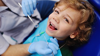 Laughing little boy in dental chair