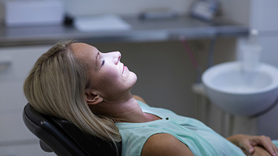 Relaxing woman in dental exam chair