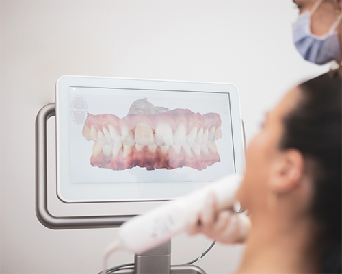 Dentist taking digital scans of a patient's teeth