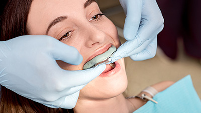 Woman being fitted for oral appliance
