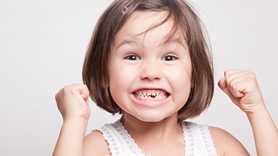 Smiling girl with missing teeth