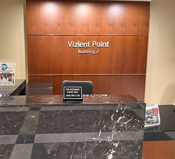 Sign on wall reading Vizient Point Building 2