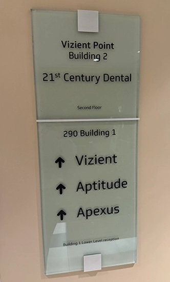 Sign on wall reading Vizient Point Building 2 21st Century Dental of Irving