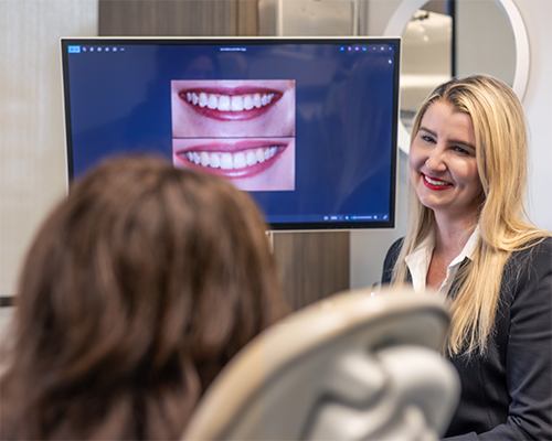 Doctor Bristow showing photos of teeth to a patient