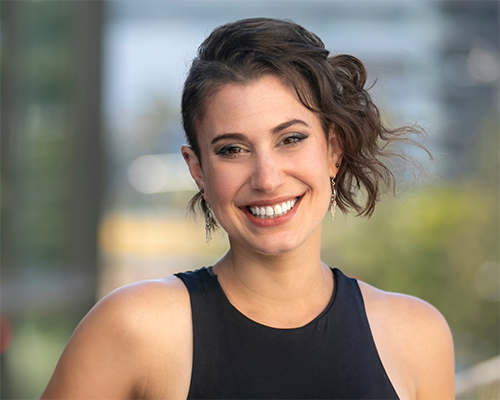 Woman in a black tank top smiling