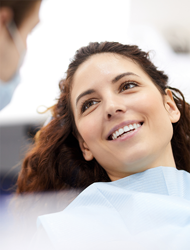 Woman in the dental chair listening to her dentist