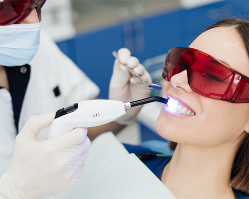 Woman getting white spots on her teeth treated at the dentist