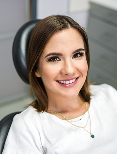 Young brunette woman smiling in the dental chair
