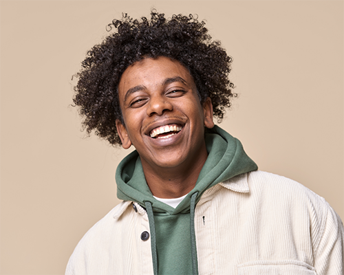 Smiling young man in a green hoodie