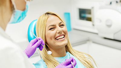 Laughing woman in dental chair