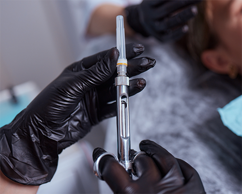 Dentist preparing a syringe