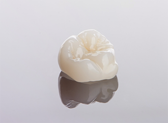Dental crown against gray background