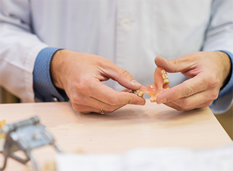 Person holding a partial denture
