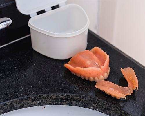 Set of dentures on a bathroom counter