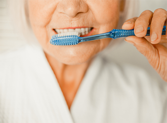 Senior woman brushing her teeth
