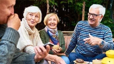 a group of older people having coffee together