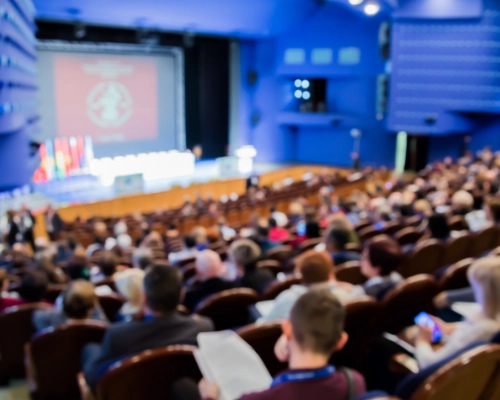 Auditorium of people watching a presentation