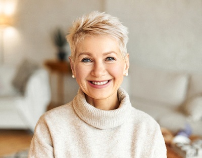 Woman smiling in grey sweater
