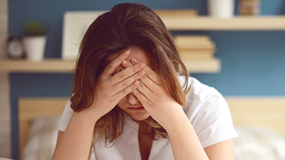 Woman with headache hoding head