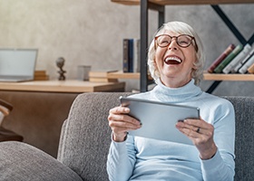 Laughing older woman, enjoying long-term benefits of dental implants