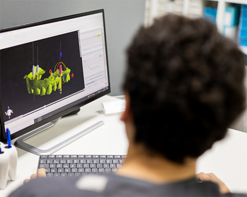 Dentist looking at digital models of a patient's jaws