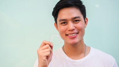 Young man holding Invisalign