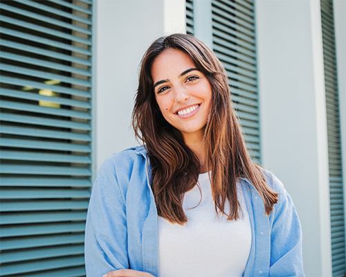Smiling brunette woman in a light blue shirt