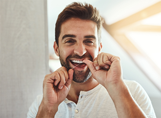 Man flossing his teeth