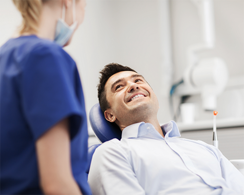 Man smiling up at his dentist