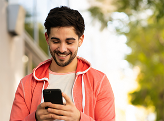 Young man smiling at his phone