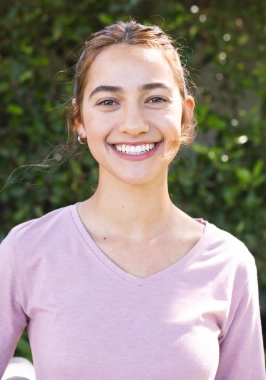 Young woman in pink blouse smiling