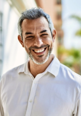 Smiling man in white collared shirt