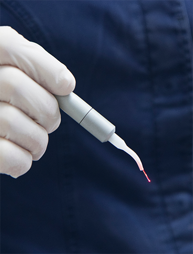 Dentist holding a laser pen