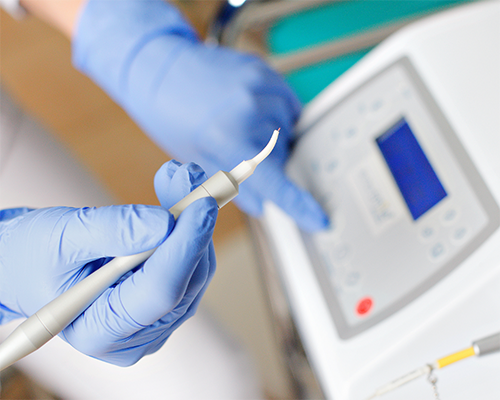 Dentist preparing to use a laser on a patient