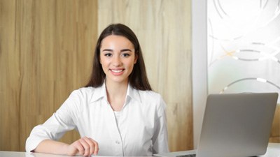 Happy dental team member, ready to assist with payments