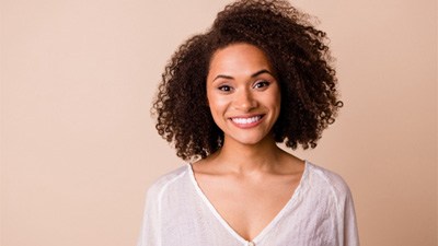 Woman with stunning smile after smile makeover service