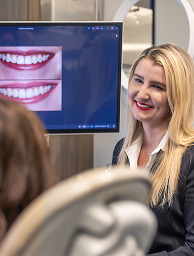 Doctor Bristow showing photos of teeth to a patient
