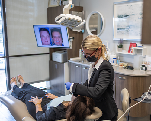 Doctor Bristow examining a patient's teeth