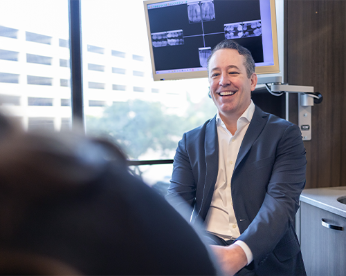 Doctor Roy smiling at a patient