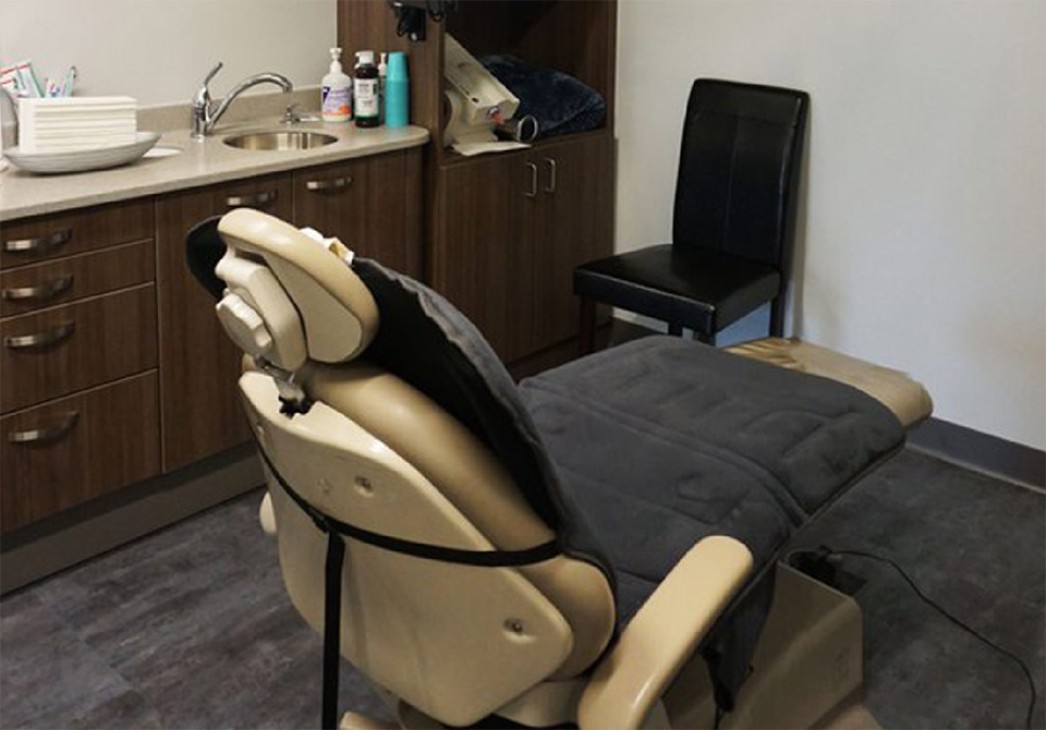 Empty dental exam chair viewed from behind