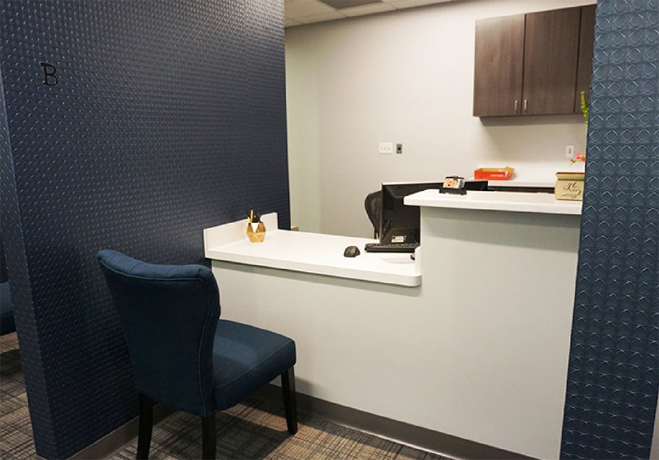 Desk with a computer in front of a chair