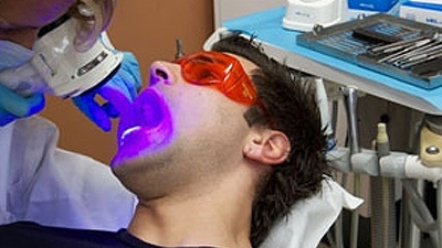 Man receiving oral cancer screening