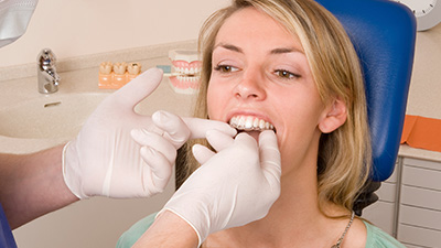 Dentist checking fit of Invisalign tray