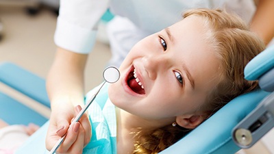 Smiling little girl in dental chair