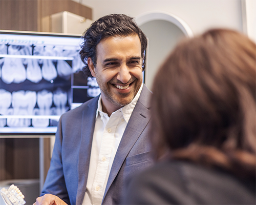 Doctor Kumar grinning at a patient