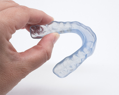 Hand holding a nightguard tray