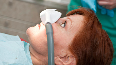 Woman with nitrous oxide nasal mask