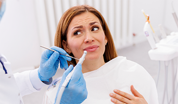 Woman looking apprehensively at her dentist