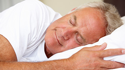 Man sleeping soundly in bed