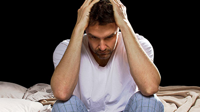 Frustrated man with head in hands